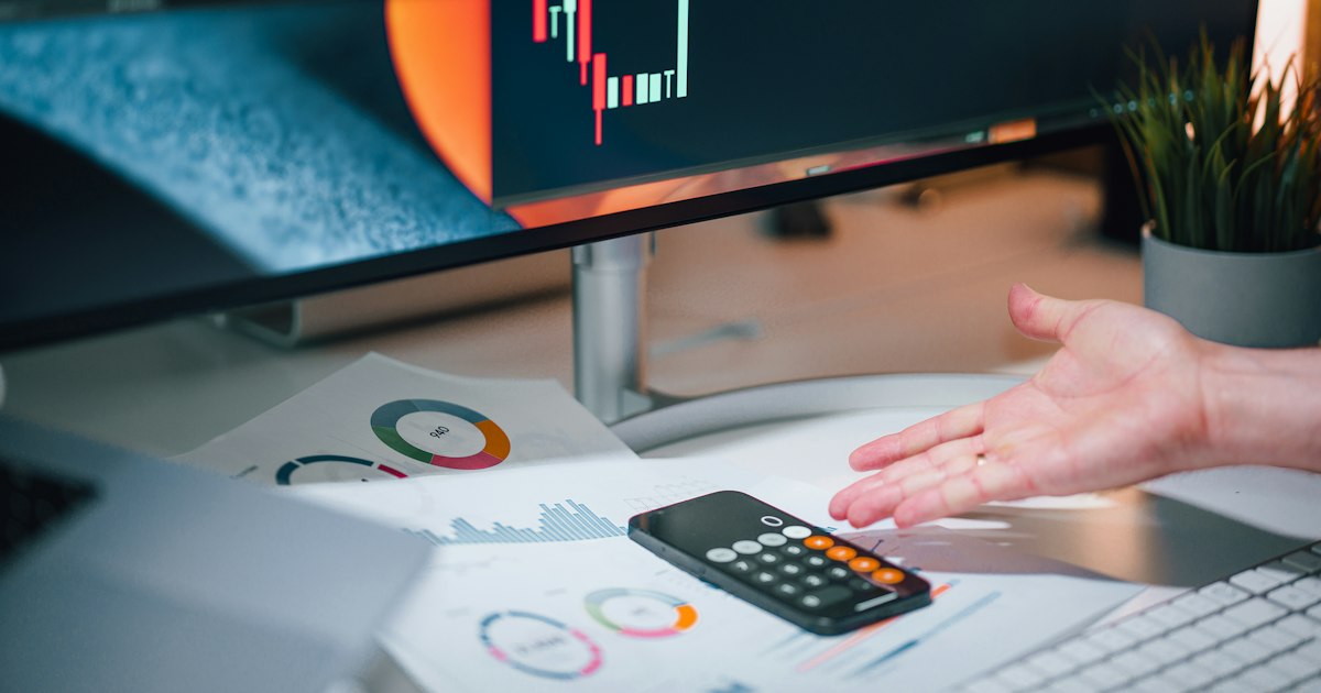 Financial charts and a calculator on a desk